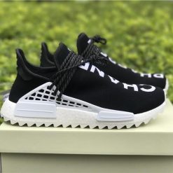 Chanel X Pharrell X Adidas Originals Hu NMD Black White replica sneakers featuring a sleek design with a combination of black and white colors, perfect for street style enthusiasts.