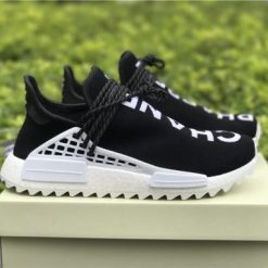 Chanel X Pharrell X Adidas Originals Hu NMD AC7190 Black White replica sneakers featuring a sleek black and white design, perfect for fashion-forward sneaker enthusiasts.