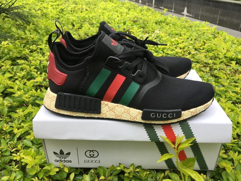 Gucci X Adidas NMD Boost Black replica sneakers featuring a sleek design with premium materials, showcasing a stylish blend of luxury and streetwear aesthetics.