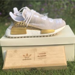 Pharrell X Adidas NMD Human Race Gold replica sneakers featuring a sleek gold and black design, showcasing premium materials and craftsmanship, perfect for sneaker enthusiasts seeking high-quality replicas.