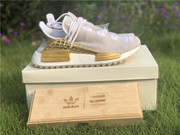 Pharrell X Adidas NMD Human Race Gold replica sneakers showcasing a vibrant gold colorway with unique design elements and premium material quality.