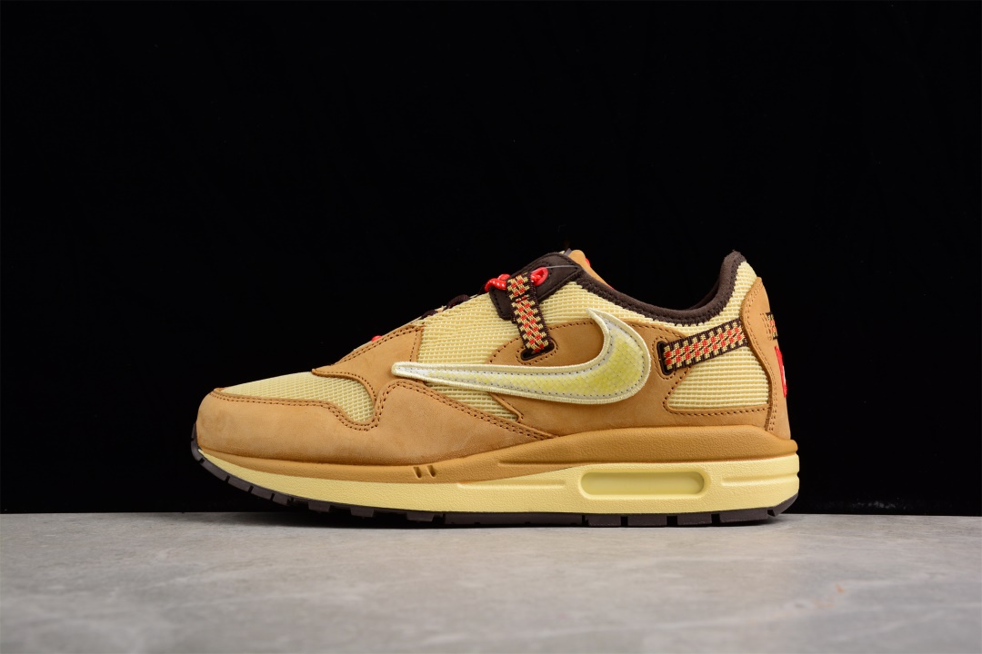 Travis Scott x Nike Air Max 1 Wheat DO9392 701 replica sneakers displayed from a side angle, featuring a rich wheat-colored upper with premium detailing, complemented by a white midsole and iconic Nike branding. Perfect for sneaker enthusiasts looking for stylish replica shoes.